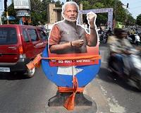 India's Modi bears all, sniffs dung with Grylls