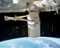 Cargo-packed Dragon arrives at space station