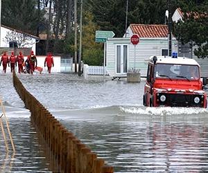 Storms batter Britain, France, disrupting travel, power