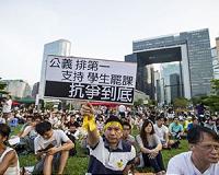 Thousands march in Hong Kong as restrictions grow