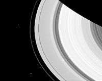 Four Moons About Saturn's Rings