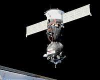 Soyuz arrives at ISS on first manned mission since October failure